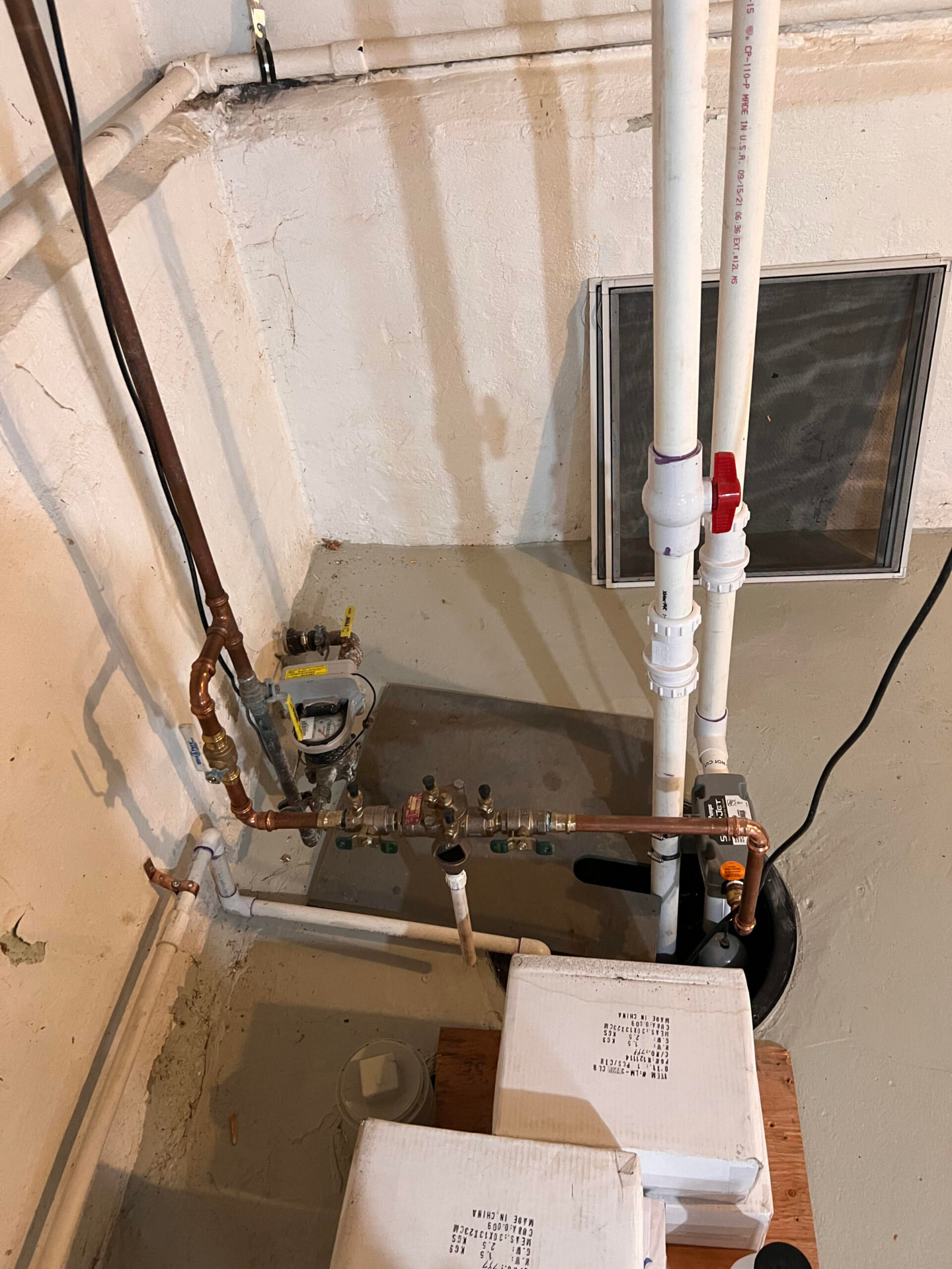 Sump pit with new pump, PVC discharge line and backwater valve
